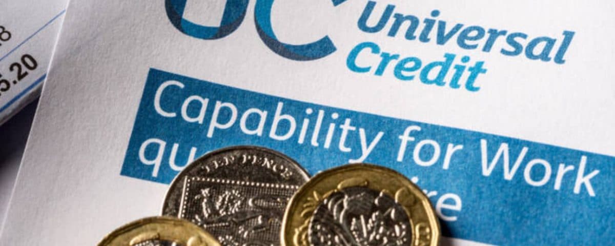 Universal Credit form with of a pile of unpaid utility-bills
